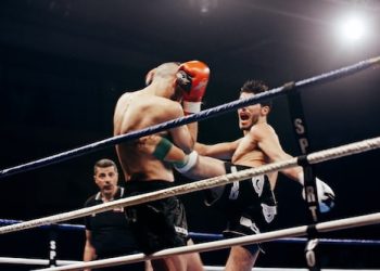 two person doing mix martial arts on white and blue stadium